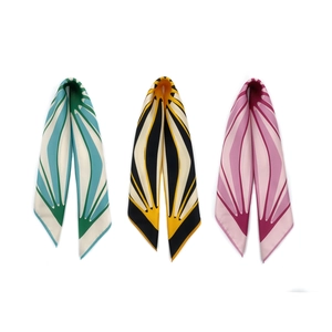 Three elegant geometric pattern silk scarves in blue, yellow, and pink on white background