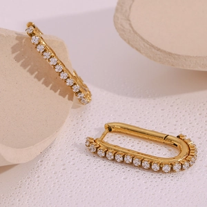 Detailed close-up of 18k gold plated U-shaped earrings with pavé set white zircon stones