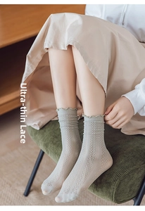 Detail of breathable hollow mesh socks with ruffled cuffs in soft bean green color