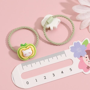 Detailed size measurement of cartoon cat apple hair ties showing dimensions with a ruler