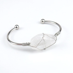 Close-up of handmade silver wire wrapped natural clear crystal hexagram open bangle