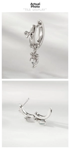 Detail view of heart-shaped crystal earrings with cute bear accent in silver finish