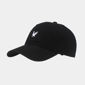 Detailed embroidery of a white eagle on a black cotton twill baseball cap with curved brim