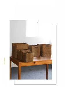 Detail of hand-woven dark brown storage baskets showing natural fiber texture and handles