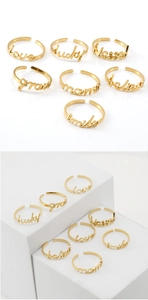 Detailed view of 18K gold plated stainless steel rings with Love and Mama script charms