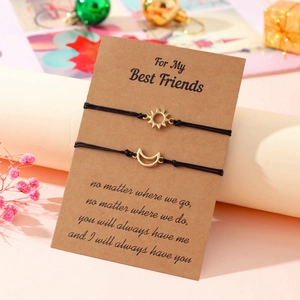 Detail of sun and moon friendship bracelets on kraft card with dry flower decoration