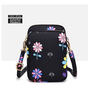 Close-up of the double zipper and colorful flower pattern on the vertical mini phone bag