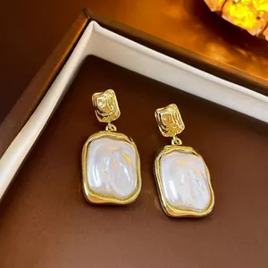 Vintage gold plated leaf heart earrings with pearls and zircon in a classic aesthetic