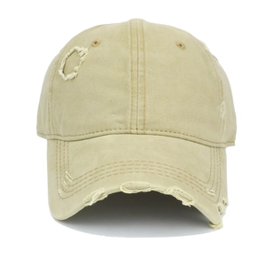 Detail view of distressed khaki cotton baseball cap with ripped holes and frayed edges