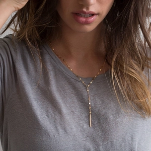 Elegant gold-tone Y-shaped lariat necklace with minimalist vertical bar pendant
