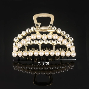 Macro shot of 7.7cm gold hair claw clip featuring rows of elegant white pearls