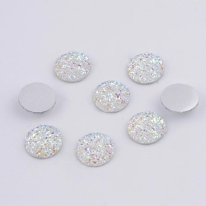 Macro detail of 14mm white resin druzy round flatback cabochons with sparkling texture