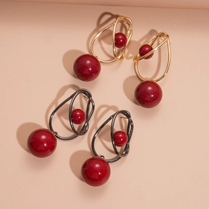 Artistic acrylic red bead earrings in gold and gunmetal twisted wire frames