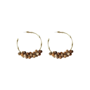 Golden spiral hoop earrings with sandalwood beads in a Bohemian C-shape design