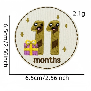 Detail of 11 months baby milestone embroidered patch with yellow gift box design