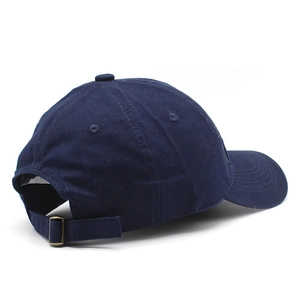 Detail of navy blue cotton baseball cap showing adjustable strap and metal buckle