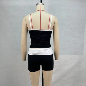 Back view of a black and white contrast cropped tank top and shorts fitness set