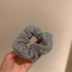 Detailed view of silver rhinestone scrunchie with sparkling crystals in high gloss finish