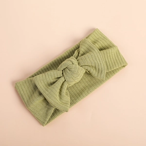 Close-up of olive green ribbed texture baby headband with a knotted bow detail