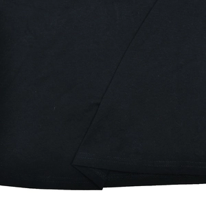 Macro shot of the hemline stitching and cotton fabric texture on a slim fit t-shirt
