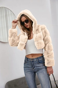 Detailed view of apricot faux fur hooded coat texture with fluffy and soft material finish
