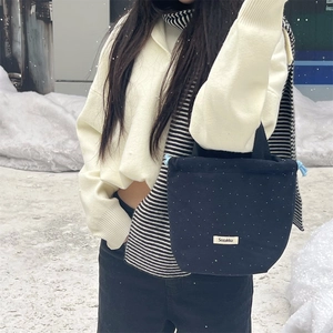Polka dot drawstring bucket bag in wool fabric with branding label for winter street style