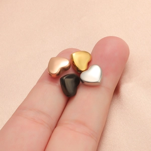 Polished heart-shaped stainless steel beads in rose gold, gold, silver, and black finish