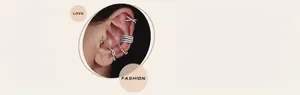 Detail of silver ear cuffs set with cubic zirconia and pearls on beige background