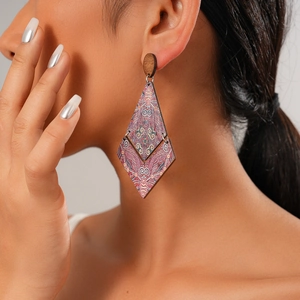 Detail of wooden bohemian earring with colorful geometric patterns and diamond shape