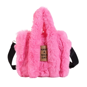 Detail of plush faux fur tote bag in magenta with HAVE A NICE DAY leather patch