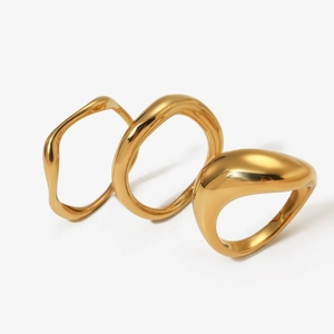 Three-piece irregular organic gold plated stainless steel rings with a polished liquid metal look