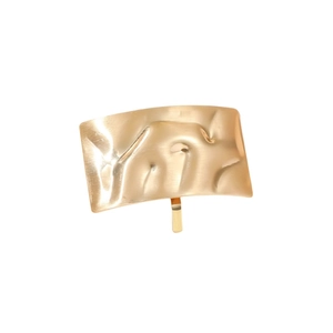 Minimalist golden textured metal ponytail hair clip with irregular hammered surface