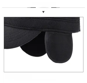 Detail of winter flat cap with folding ear flaps and metal fashion plaque decoration