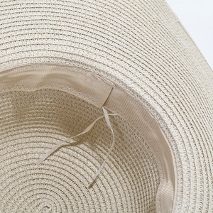 Adjustable wide brim straw sun hat with detailed woven texture for beach vacation