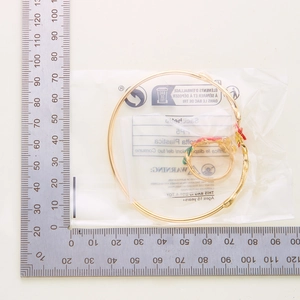 Detailed size measurement of a gold floral ring and thin bangle jewelry set
