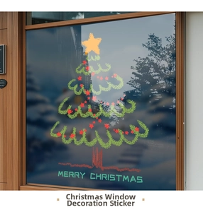 Detail view of a green hand-drawn Christmas tree window sticker on a store glass pane