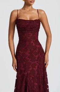Detailansicht des burgunderroten Jacquard-Blumenstoffs und des gerafften Mieders am Maxikleid