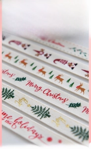 Detailed macro view of beige Christmas cotton ribbon with reindeer and tree prints