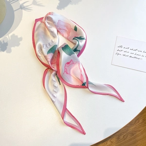 Detail of floral silk scarf with rose patterns and pearl border on an elegant background