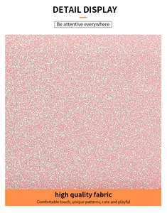 Detailed close-up of pink glitter fabric texture on a long zip wallet for women