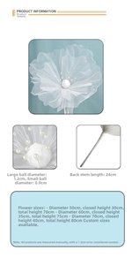 Detailed view of large white organza wedding flower with pearl core and silver stem