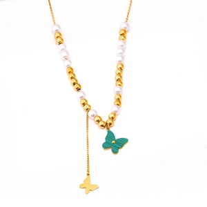 Golden butterfly fringe necklace with green pendant and pearls on a white background