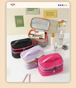 Detail of the double-layer mesh cosmetic bag with portable handle and zipper closure