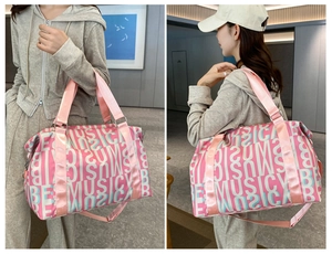 Pink and blue duffel bag with music and summer print shown on a model in a modern room