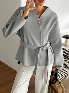 Detail of casual grey tie-waist short blazer jacket showing soft fabric texture
