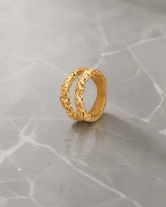 Detail of vintage gold textured open cuff bracelet with hammered metal finish