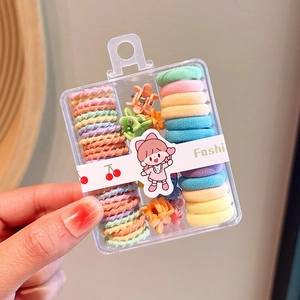 Close-up of macaron colored hair accessories set in a transparent storage box