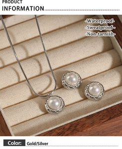Detailed macro view of silver snake chain necklace and pearl earrings in a premium jewelry box