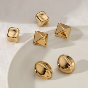 Three pairs of vintage gold stainless steel earrings in square, pyramid and bean shapes