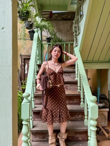 Detail of brown polka dot two-piece set featuring backless top and ruffled mermaid skirt